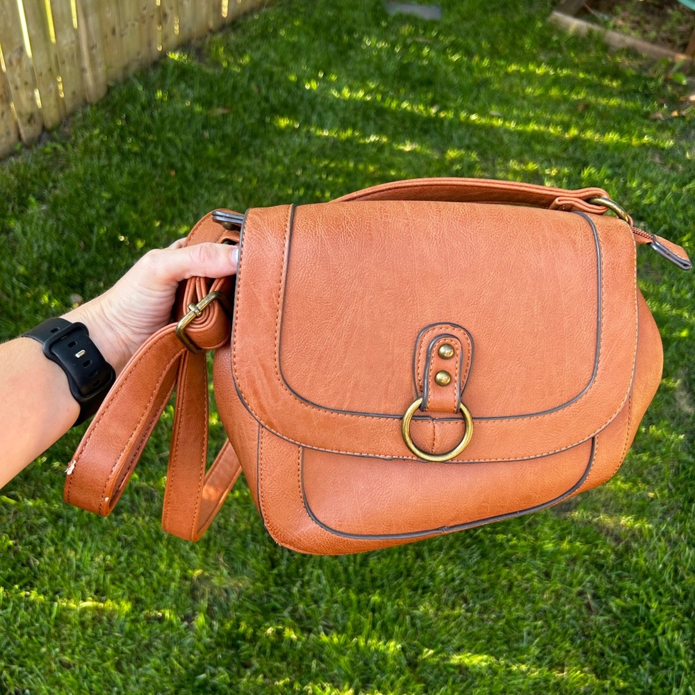Tan pleather bass crossbody bag.